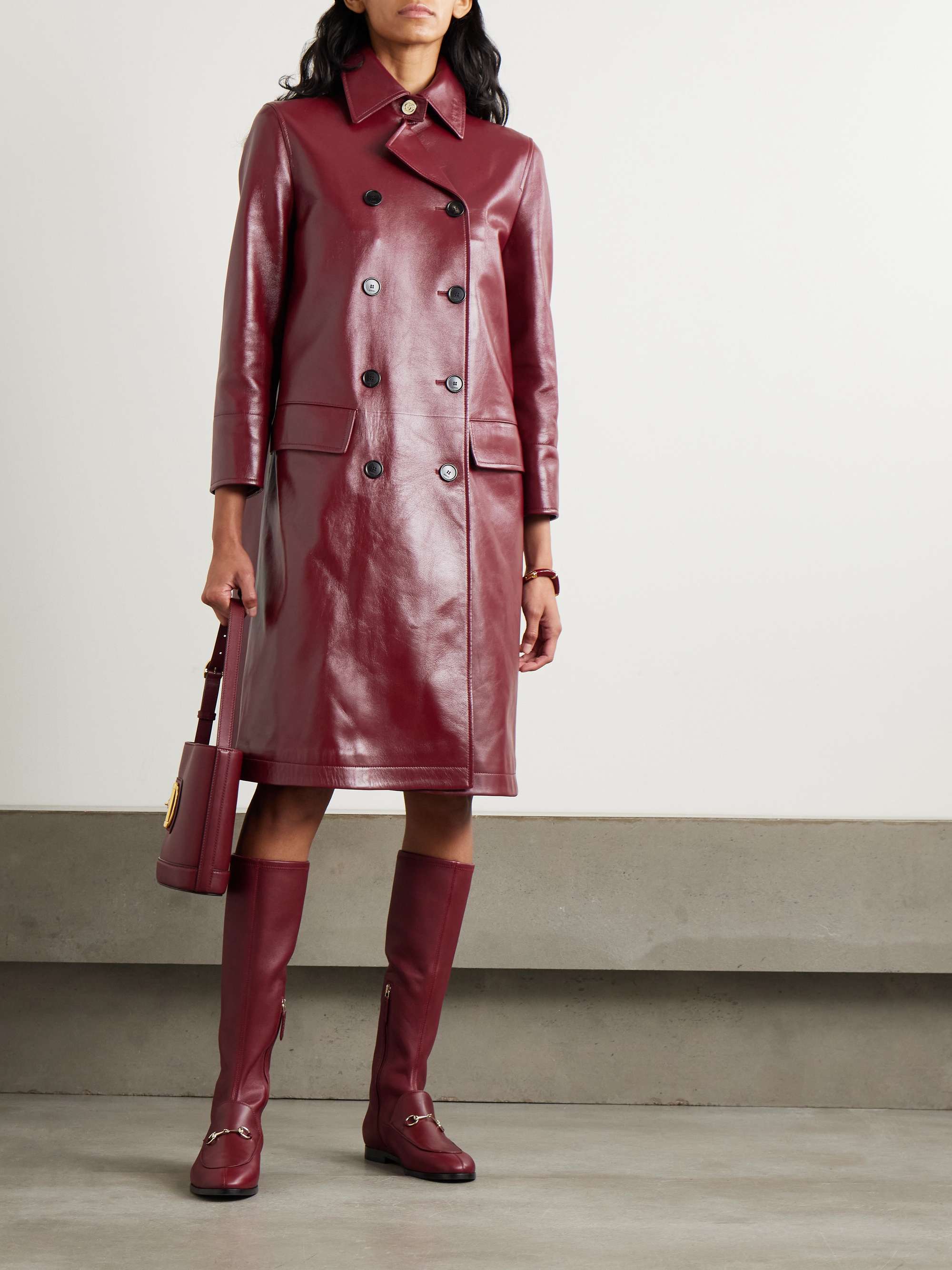 Double-breasted glossed-leather trench coat view