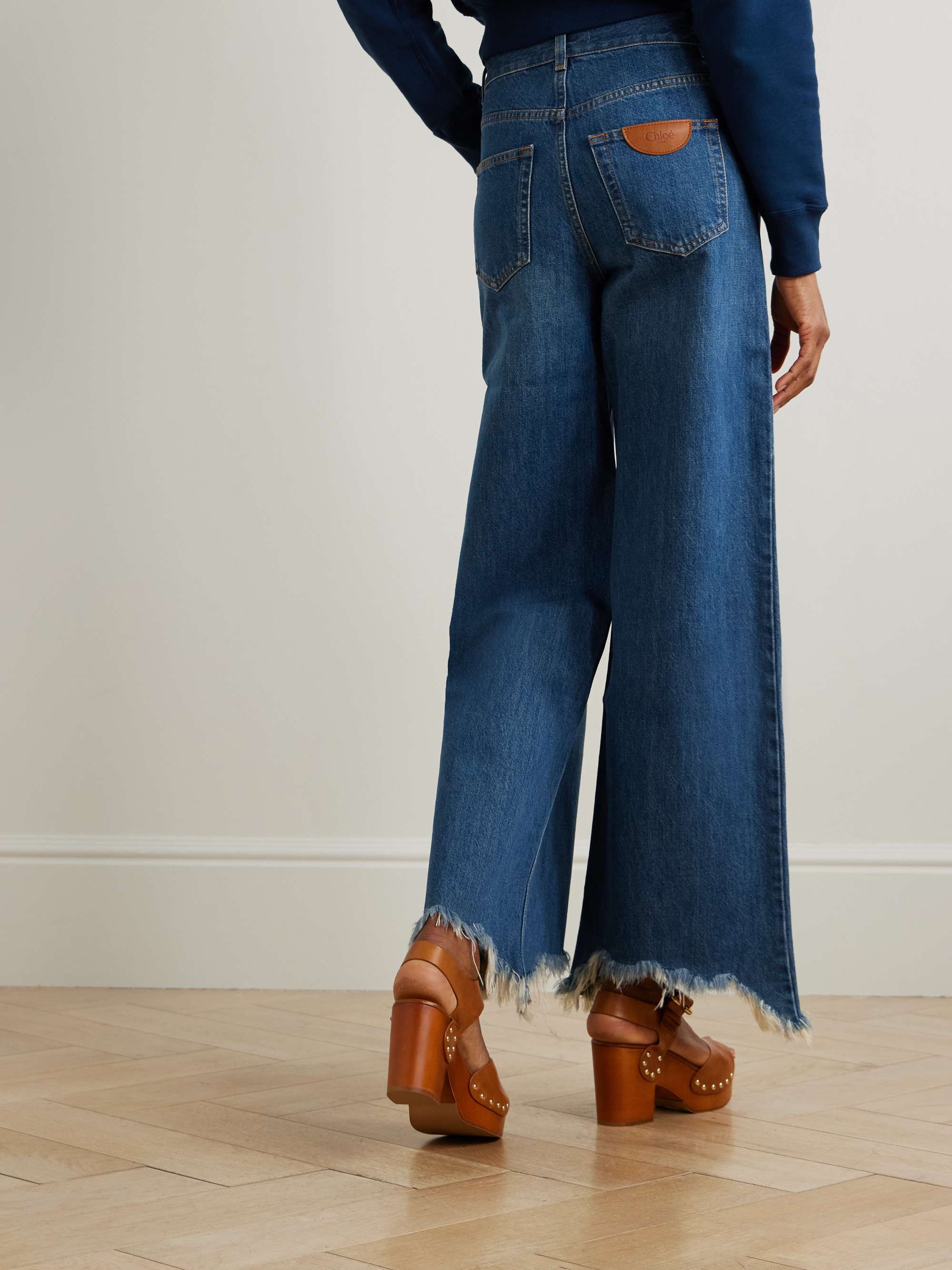 Cropped distressed high-rise wide-leg jeans view